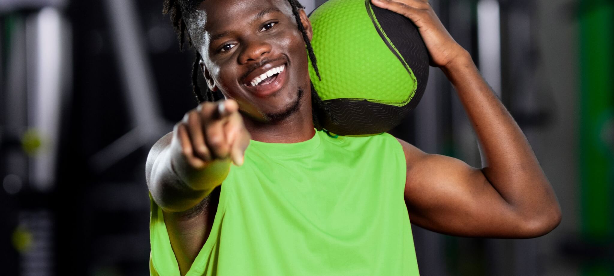 man smiling at the camera holding a ball